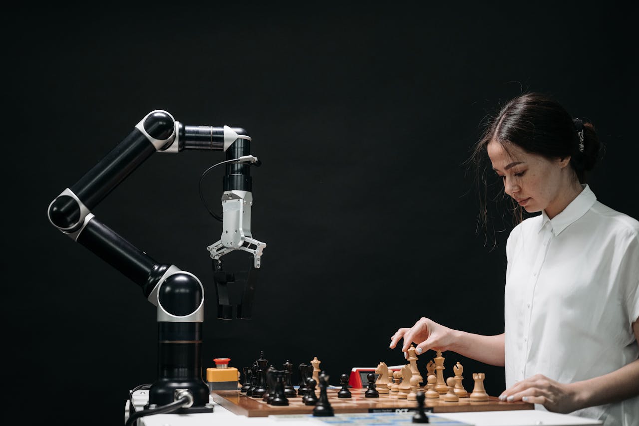 about-01 A woman plays chess against a robotic arm, showcasing AI innovation in a modern setting.